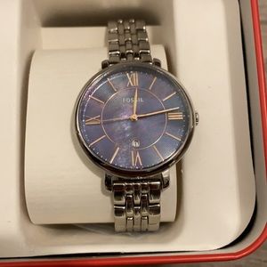 Women’s fossil watch, silver. Teal/purple watch face.